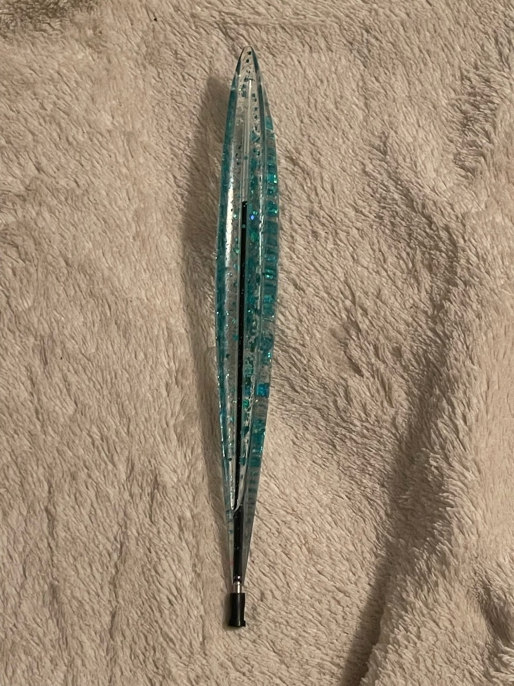 Handcrafted pen for with teal glitter . Blue Ink .